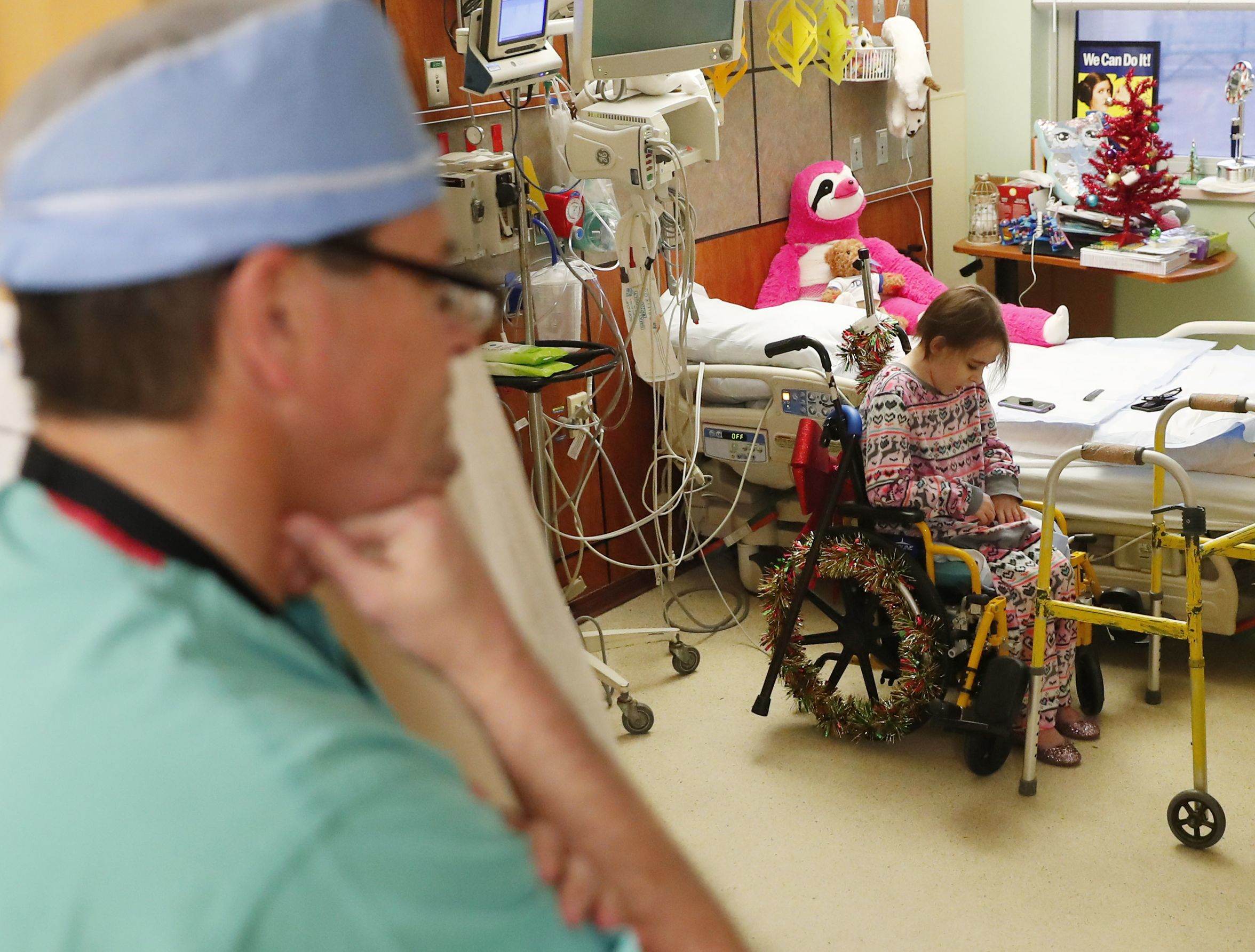 Dr. Kevin Foster talks with Isabella McCune in her room at the Arizona Burn Center in Phoenix Dec. 12, 2018. The 9-year-old was severely burned in a home accident in March.