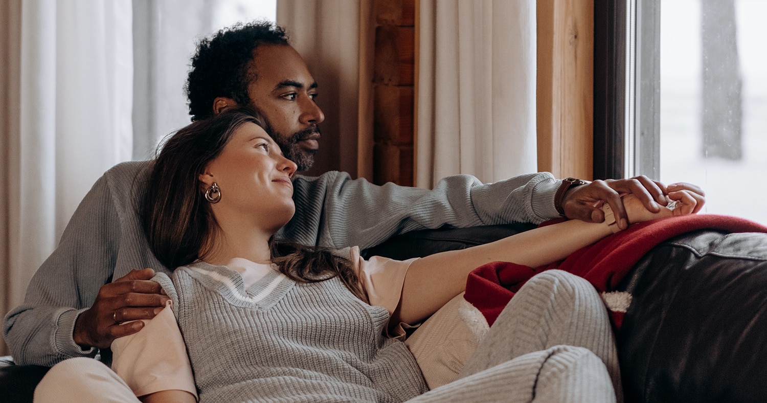 couple cuddling on couch