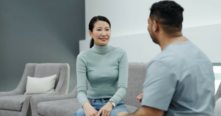 Happy patient talking with doctor